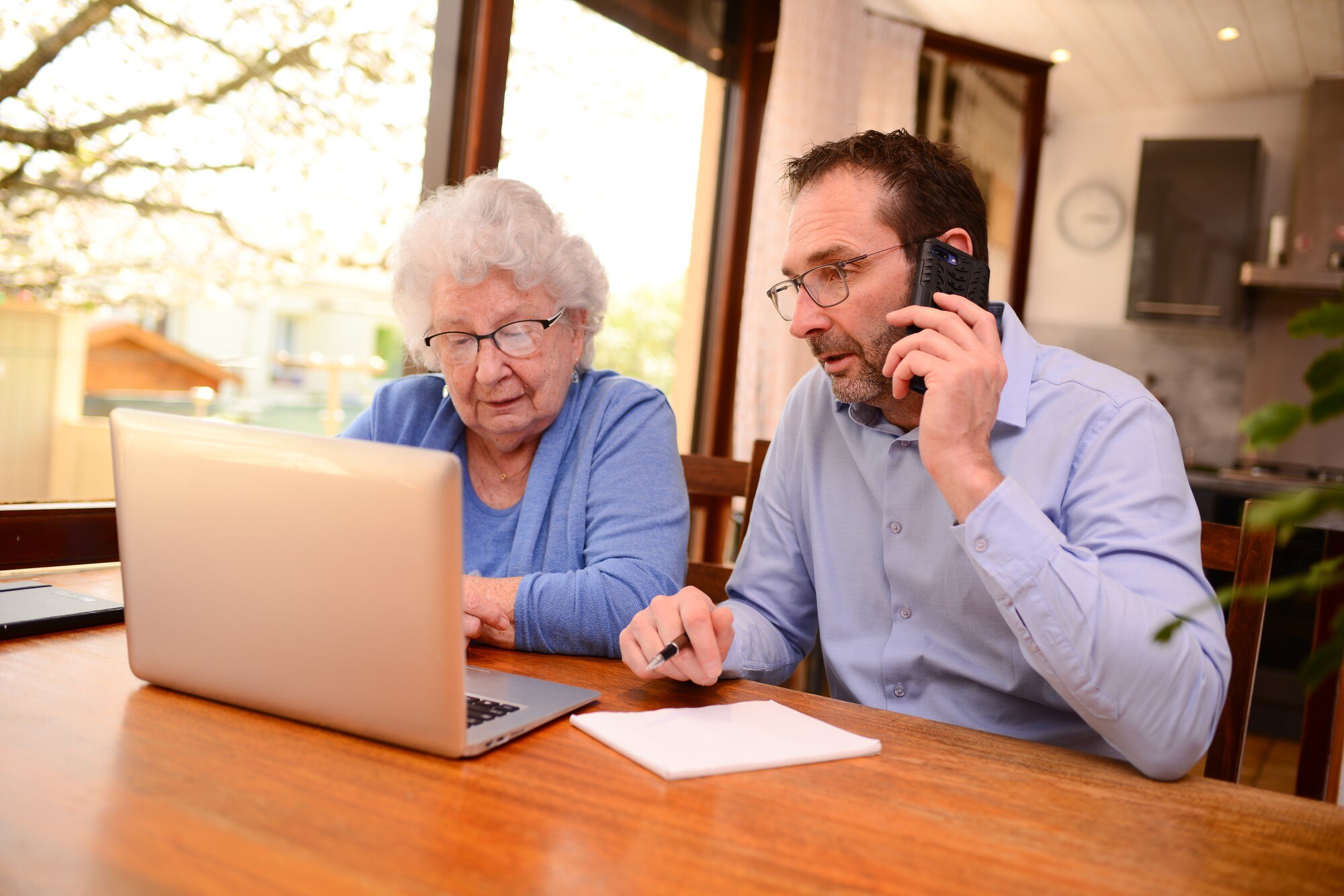 mature man helping elderly senior woman home with paperwork computer internet lesson 271254 249